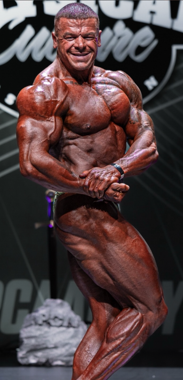 Jay Davies bodybuilder on stage competing in open heavyweight bodybuilding during 2025 season